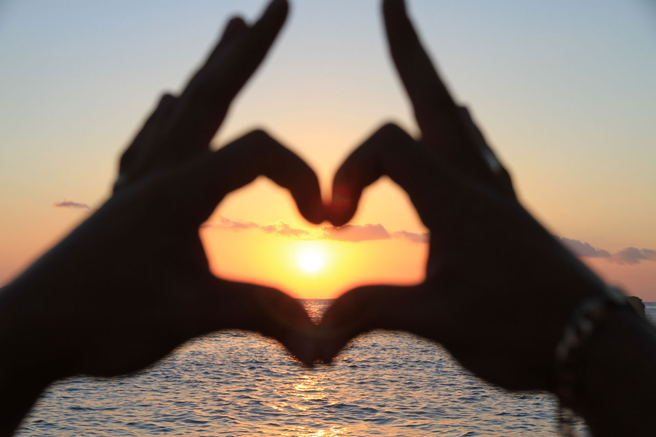 Ibiza sunset hand heart
